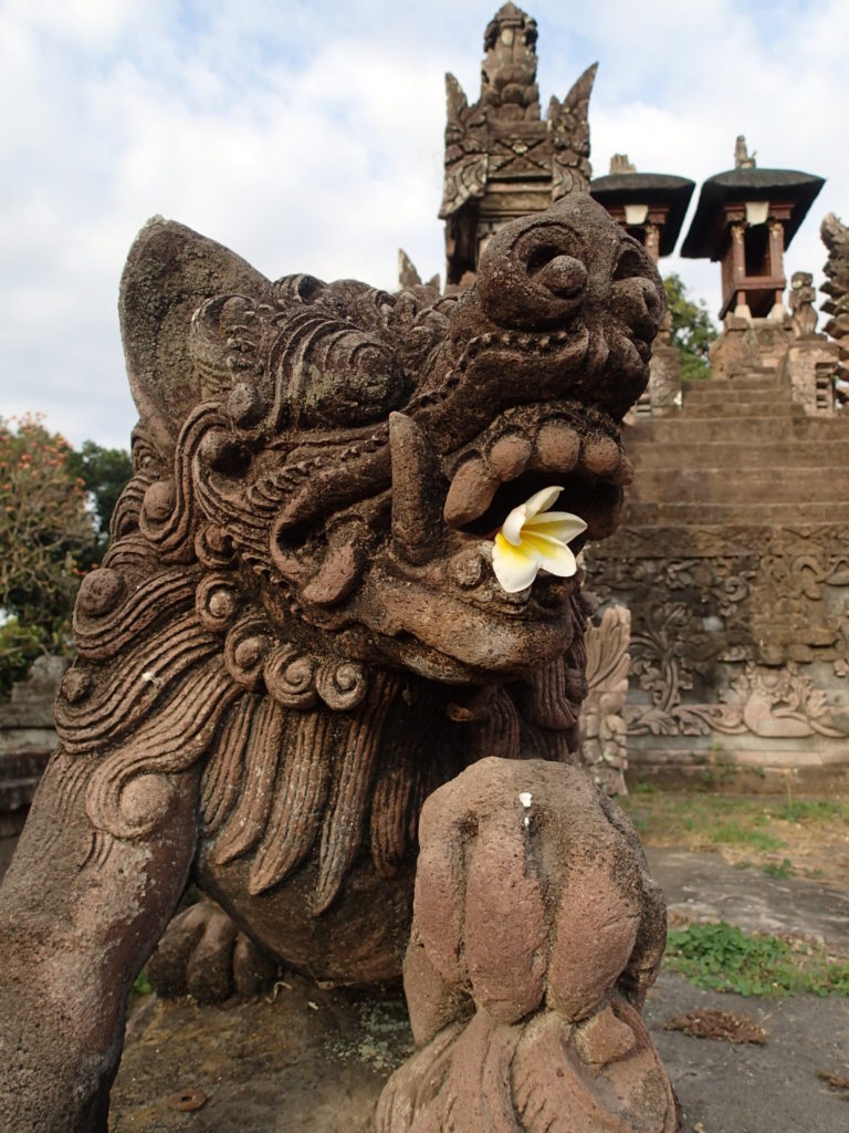 Beji Temple Bali statue and flower